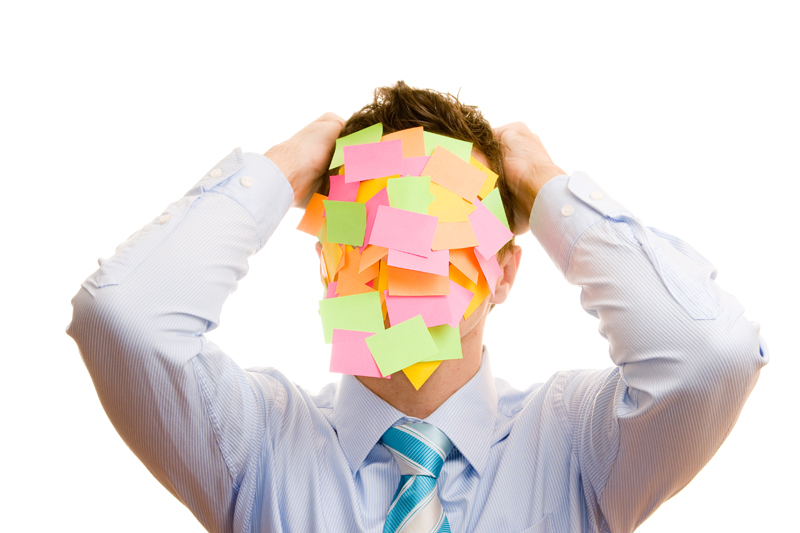 Businessman covered with memos on white background